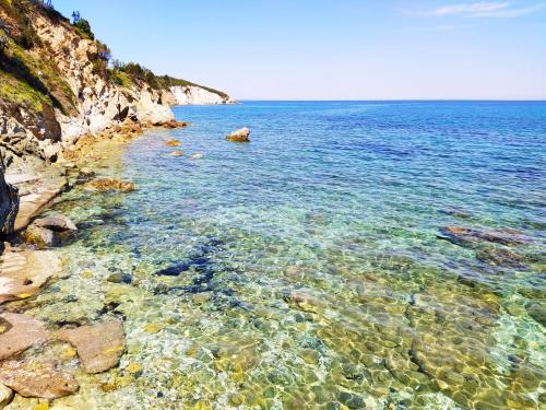 a large body of water with a rocky shore at Ghiaie sea view in Portoferraio