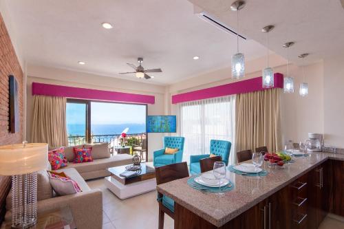 a kitchen and living room with a table and chairs at NISE in Puerto Vallarta