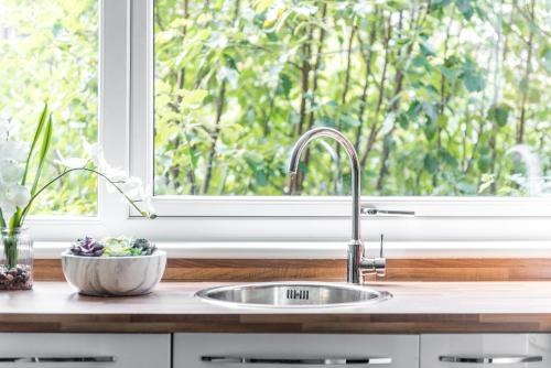 a kitchen sink in front of a window at City Centre Stylish Apartment With Free Parking in Edinburgh