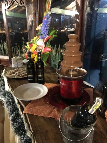 a table with a bunch of vases and a plate at Hotel Cabañas San Cayetano in Paipa