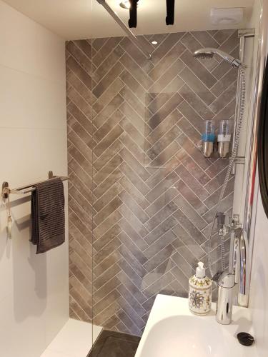 a bathroom with a shower and a sink at Southpoint Zandvoort & private parking in Zandvoort