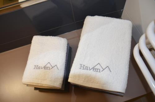 two towels on a table with the words hawaiian at Czarna Góra Haven in Sienna