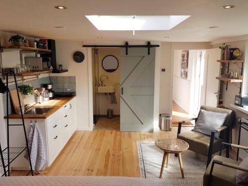 a kitchen with a sliding barn door and a living room at Southpoint Zandvoort with free parking in Zandvoort