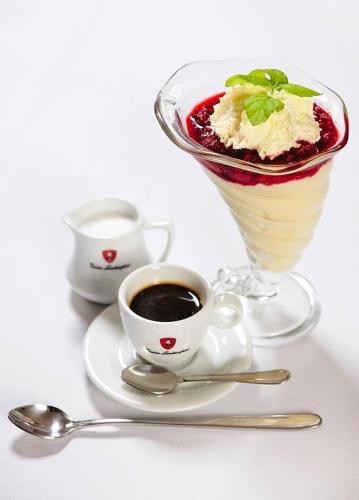 a dessert and a cup of coffee on a plate at Hotel Kazimierski Zdrój in Janowiec