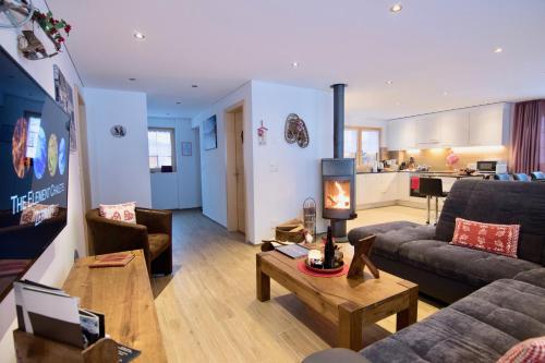 a living room with a couch and a table at Element Chalets Zermatt in Zermatt