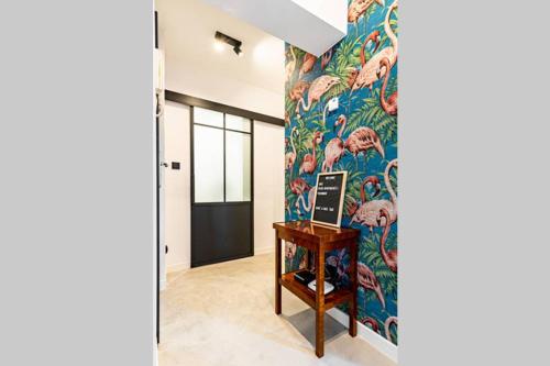 a hallway with a wall with a colorful wallpaper at Blick Apartments - Riverview Soft Loft in Zgorzelec