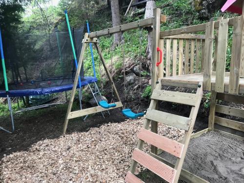 a playground with a ladder and a swing at Chalet Burglauenen Grindelwald in Grindelwald