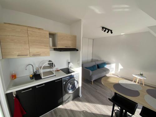 a small apartment with a kitchen and a dining room at Escapade à Cabourg, 300M plage, calme et chaleureux in Cabourg