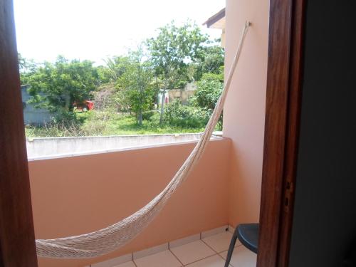 a hammock hanging from a window in a room at Hotel Pousada Paraíso das Águas in Barreirinhas