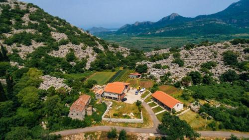 an aerial view of a house on a mountain at Apartments EcoNature in Virpazar