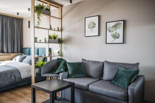 a living room with a couch and a bed at Best View In Apartment in Liepāja