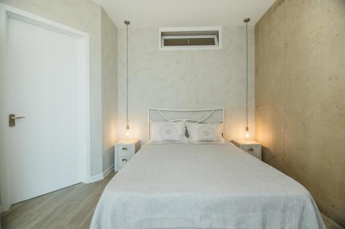 a bedroom with a large bed with two night stands at New Wave 1 in Batumi