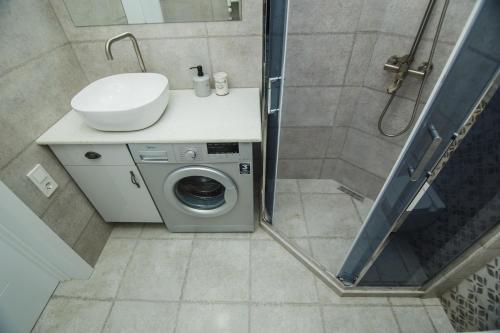 a bathroom with a washing machine and a sink at New Wave 1 in Batumi