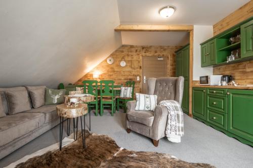 a living room with a couch and a table at Villa Adamo & Relax in Zakopane
