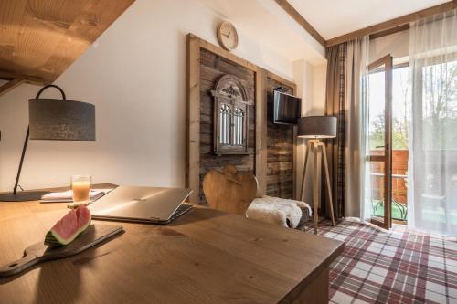 an office with a table with a laptop on it at Villa Adamo & Relax in Zakopane