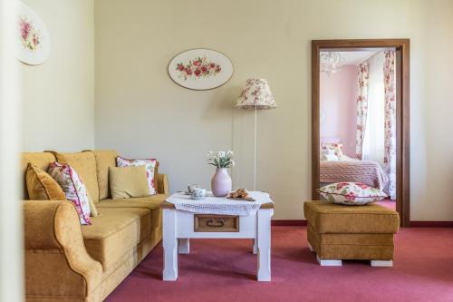 a living room with a couch and a table at Villa Adamo & Relax in Zakopane