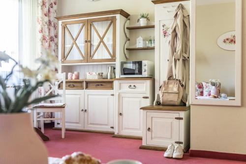 a kitchen with white cabinets and a microwave at Villa Adamo & Relax in Zakopane
