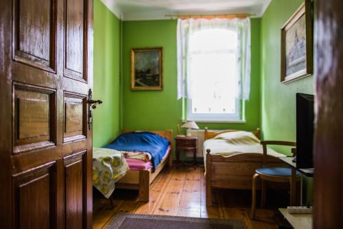 Кровать или кровати в номере Noclegi na Polnej