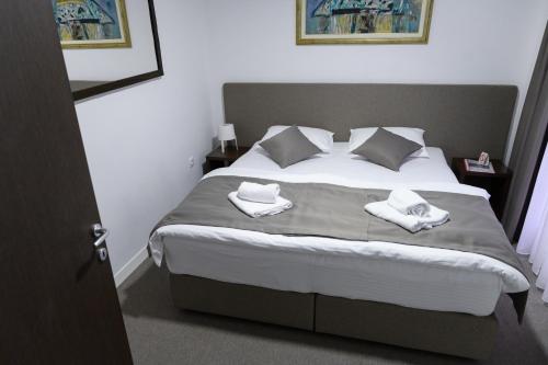 a bedroom with a bed with two towels on it at Jezero Kudrec in Smederevska Palanka