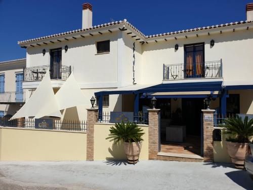 a large white house with a porch and balcony at ''EPAVLIS boutique GALAXIDI'' in Galaxidi