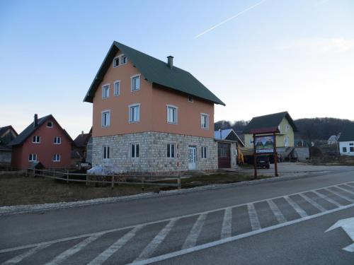 a large building on the side of a road at Rooms and Bungalows Sreten Žugić in Žabljak