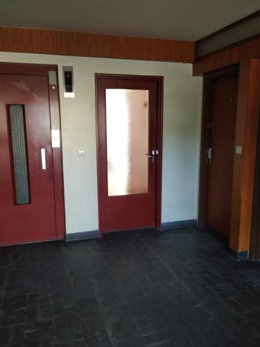 two doors in a room with brick flooring at ZEN T1, 500m centre, proche gare, tout confort in Châlons-en-Champagne