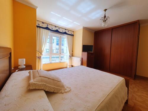 En eller flere senge i et værelse på APARTAMENTO VACACIONES MUXÍA