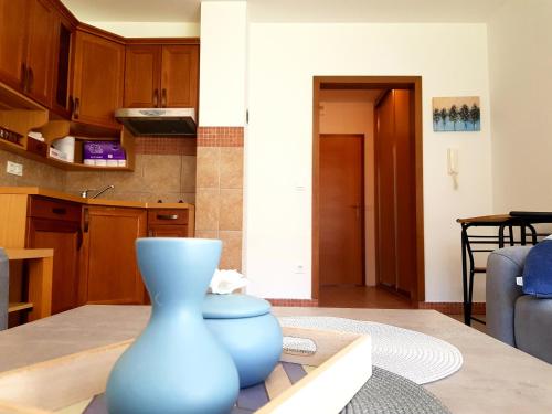 a blue vase sitting on a table in a kitchen at Vlasicka avantura Eko Fis 509 in Vlasic
