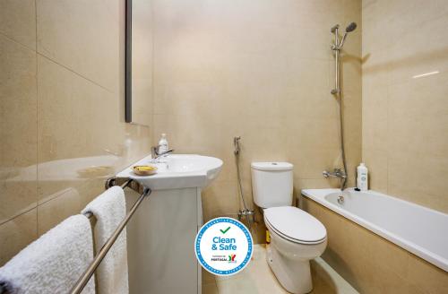 a bathroom with a toilet and a sink and a bath tub at Ebora Home - free garage - Centro Histórico in Évora