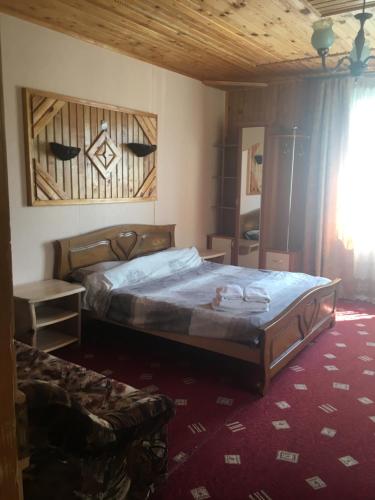 um quarto com uma cama grande num quarto em Guest house Zatishniy dvir em Yaremche