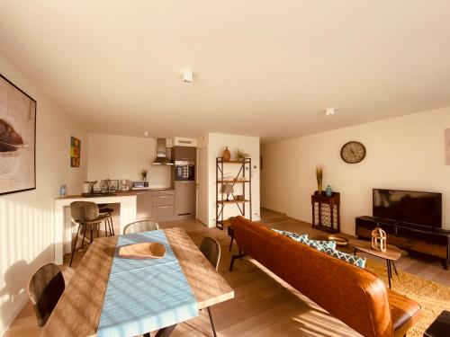 a living room with a couch and a table at Luxury Apartment Mons City Center in Mons