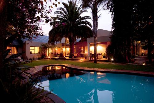 a swimming pool in the yard of a house at African Rock Hotel and Spa in Kempton Park