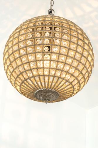 a large rattan light fixture hanging from a ceiling at Lisboa Prata Boutique Hotel in Lisbon