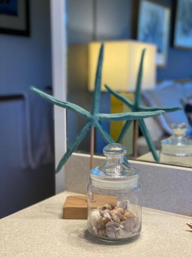 a glass jar with rocks in it on a table at Perfect for families and couples - Maui Sunset A-203 in Kihei