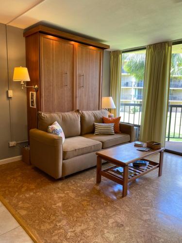 a living room with a couch and a coffee table at Perfect for families and couples - Maui Sunset A-203 in Kihei