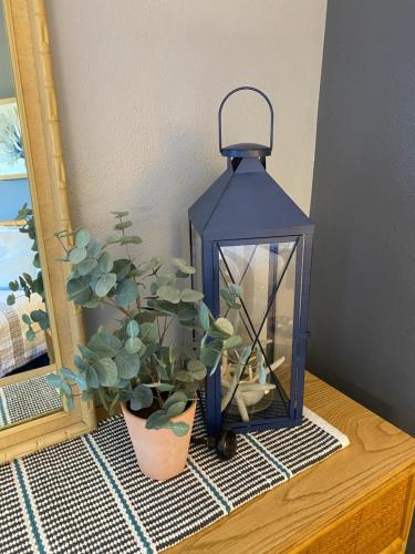 a lantern sitting on a table next to a potted plant at Perfect for families and couples - Maui Sunset A-203 in Kihei