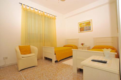 a bedroom with two beds and a chair and a desk at Andreina a San Pietro Apartment in Rome