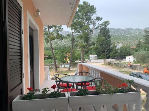 a patio with a table and chairs on a balcony at Apartmani Spomenka in Seline