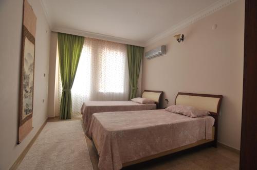 Rúm í herbergi á Cebeci Apartments - Extrahome