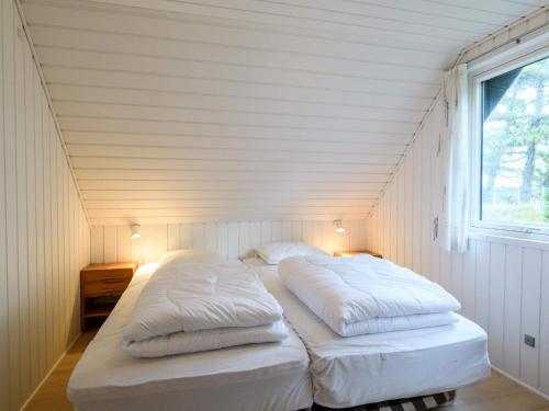 Un ou plusieurs lits dans un hébergement de l'établissement Holiday home Fanø XLIV