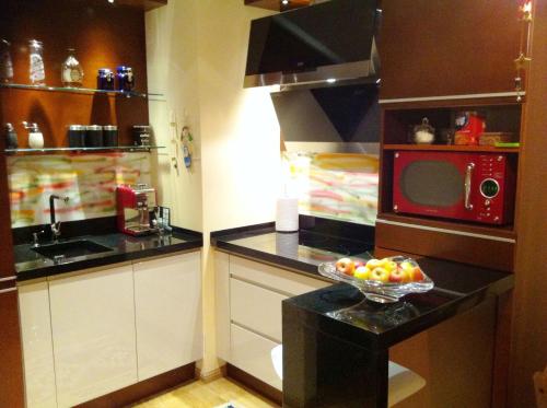 a kitchen with a bowl of fruit on a counter at Patio Mare Amber in Sopot