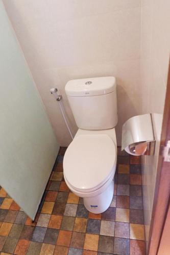 a bathroom with a white toilet in a room at The Kayuri in Canggu
