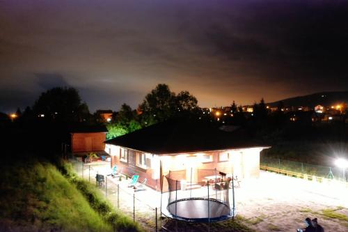 a building with a basketball hoop at night at Apartamenty przy Jeziorze Żywieckim z widokiem na Skrzyczne in Żywiec