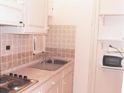 a kitchen with a sink and a microwave at Residence Panama in Alassio