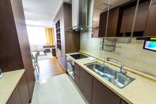 a kitchen with a sink and a stove at THEADDRESS HIGHVILL Astana in Promyshlennyy