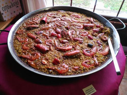 a large pan of food on a table at HOTEL MASIA EL MOLINETE in Mora de Rubielos