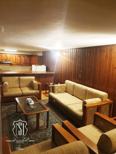 a living room with a couch and a table at Saint Michel Chalets in Al Arz