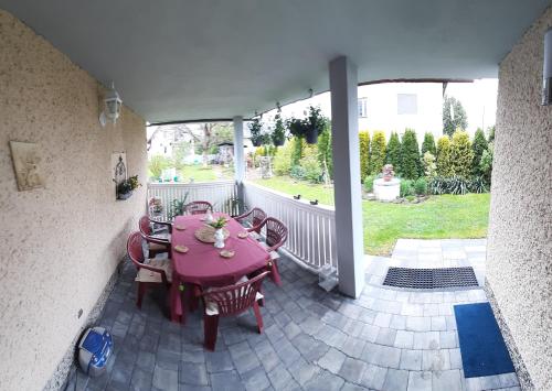 a pink table and chairs on a patio at Lawendowy Dom in Besko