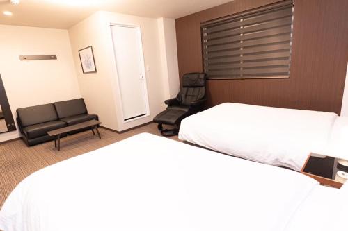 Ένα ή περισσότερα κρεβάτια σε δωμάτιο στο Hotel Kojan