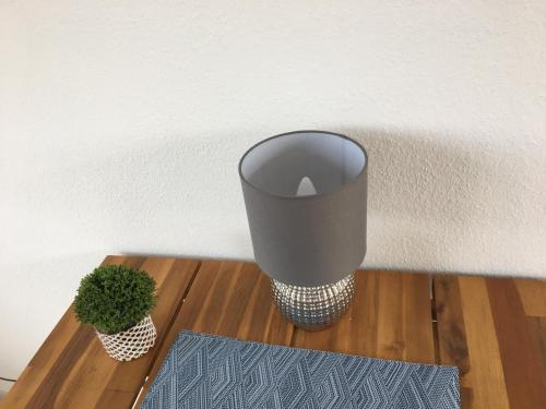 a vase sitting on a wooden table with a plant at Apartment Brander Blick in Aachen
